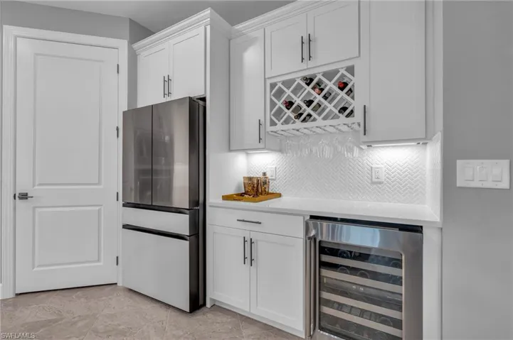 Kitchen with pull out drawers in cabinets, wine fridge and coffee bar
