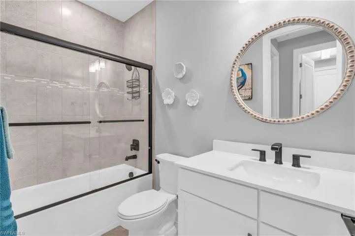 3rd bathroom with a glass enclosed bath/shower