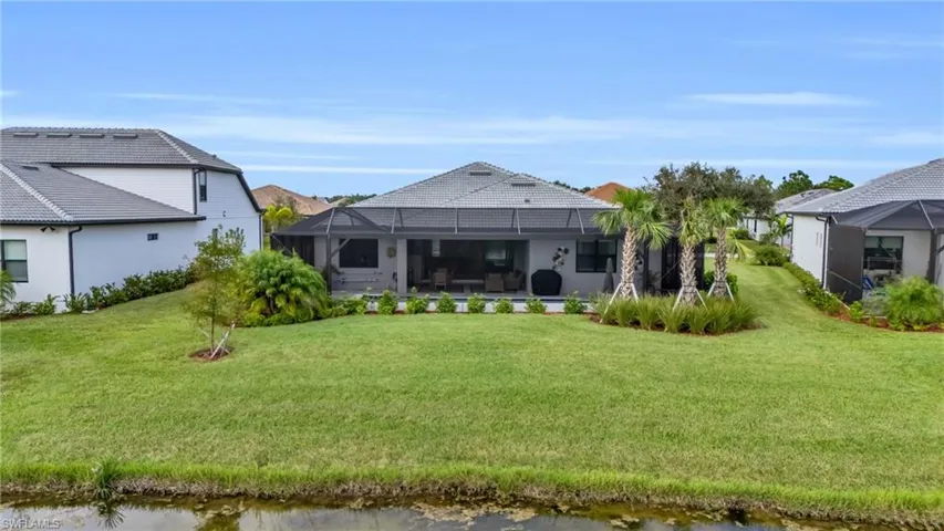 View of yard featuring a lanai and a water view