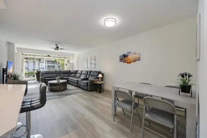Living room featuring ceiling fan and light hardwood / wood-style flooring