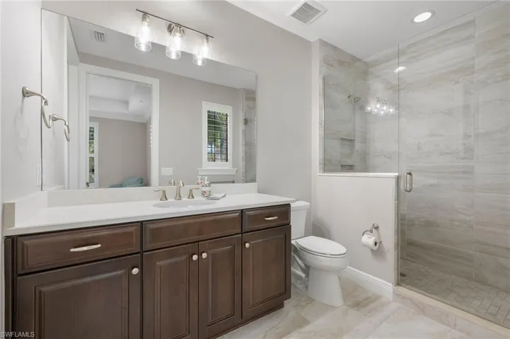 Guest Bathroom 1 with a walk in shower.