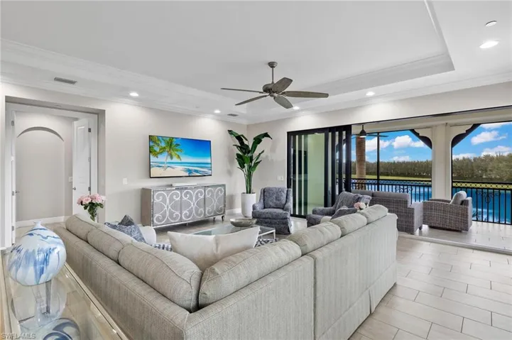Great Room featuring a tray ceiling, crown molding, ceiling fan, and recessed lighting.