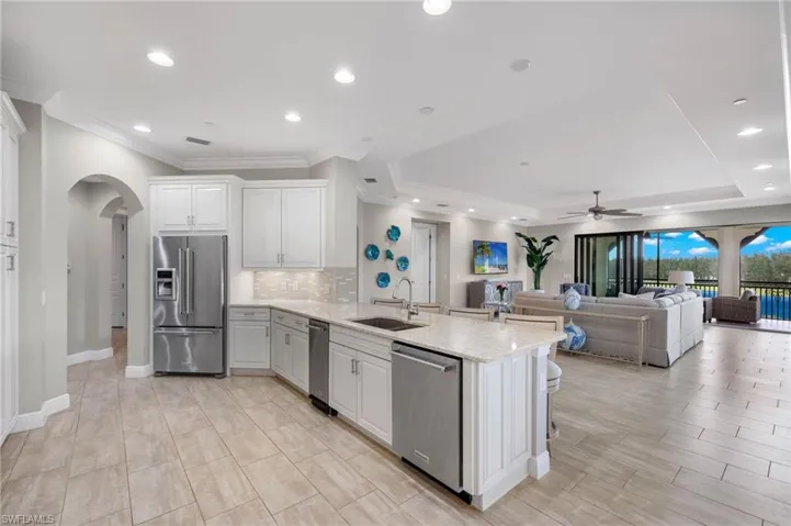 Kitchen with a peninsula, appliances with stainless steel finishes, and decorative backsplash.