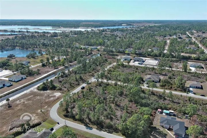 View of property location featuring a large body of water and nearby suburban area