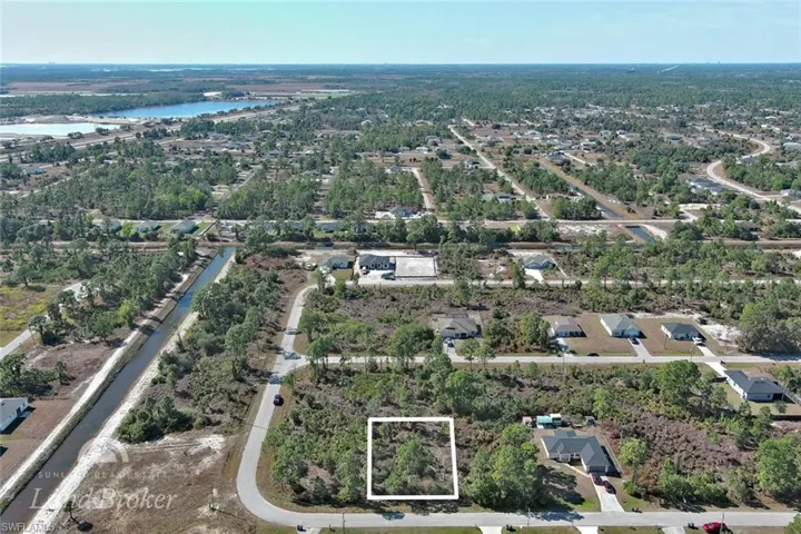 Aerial overview of property's location with property parcel outlined and a nearby body of water
