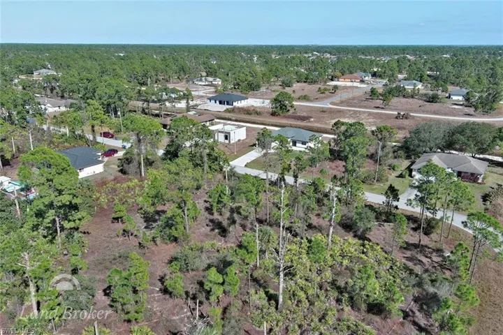 Aerial view of property's location with nearby suburban area