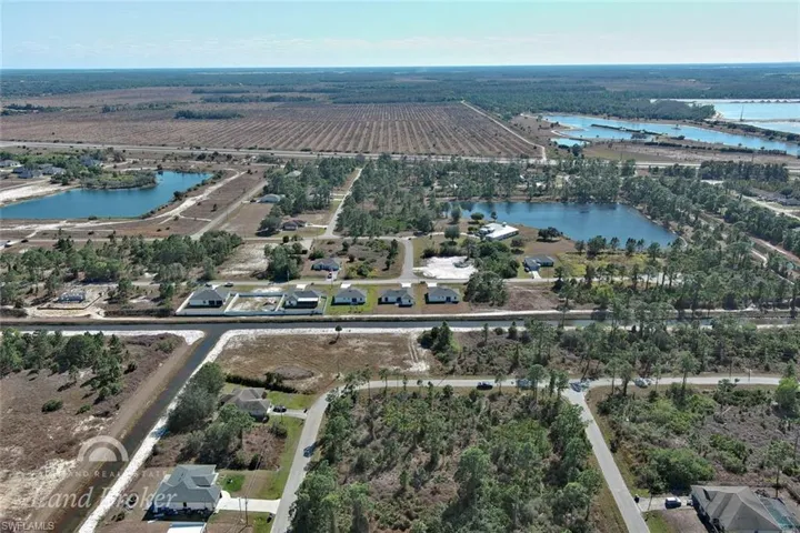 Aerial view of property's location featuring a large body of water and rural landscape