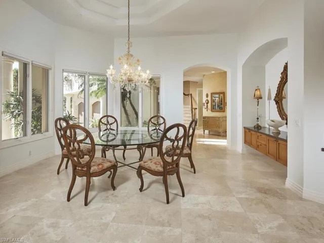 Volume ceilings and a ton of windows in this formal dining area.