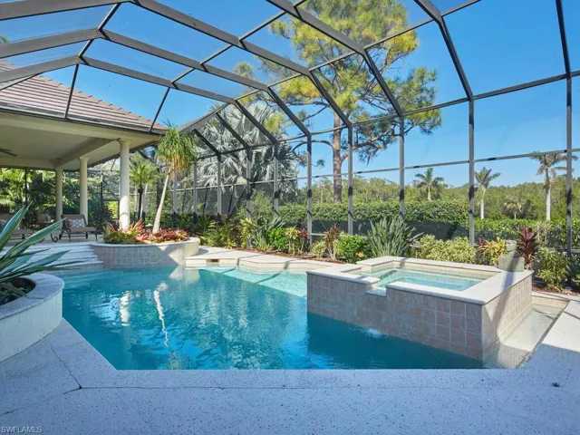 Beautifully landscaped outdoor pool area with a relaxing spa!
