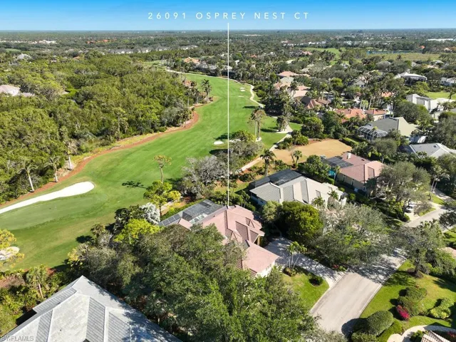 Aerial view of home and golf course behind.