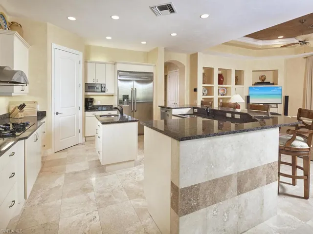 Plenty of white cabinetry, a kitchen island and lots of light!