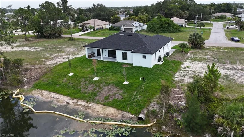 Contemporary single-story residence with a dark shingle roof and white stucco exterior