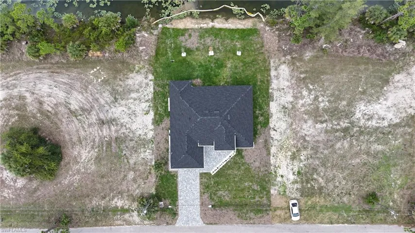 New construction property featuring a dark shingle roof and light-colored siding