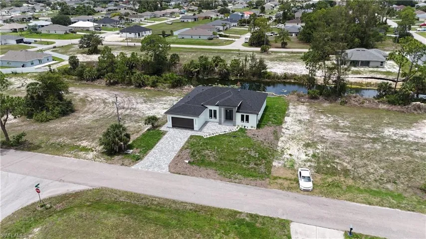 Contemporary single-story residence with a dark gray shingle roof and light-colored siding