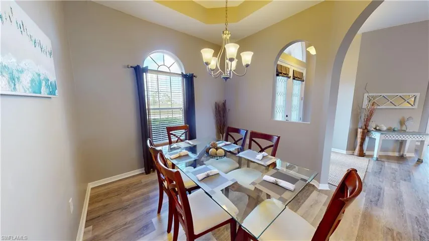 Dining room with an inviting chandelier and light wood-type flooring