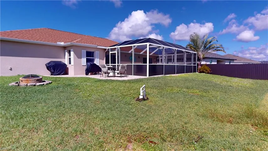 Rear of home featuring pool, paver patio and firepit
