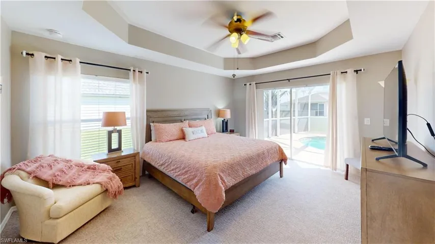 Primary bedroom with sliding glass doors to pool