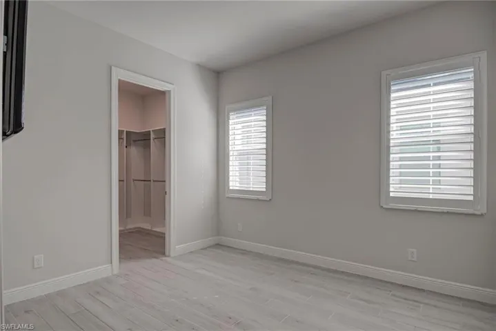 2nd bedroom with light wood-style floors and a spacious closet