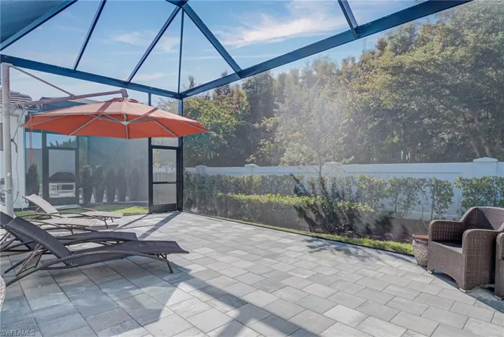 View of patio / terrace featuring glass enclosure and a sunroom