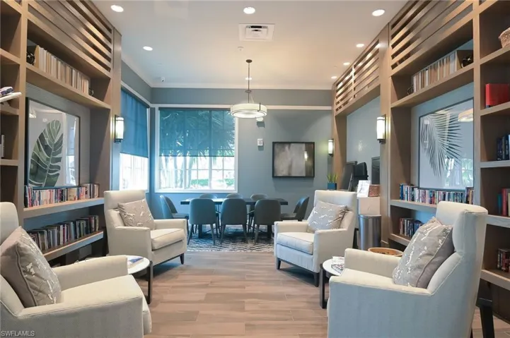 Living area featuring ornamental molding and recessed lighting