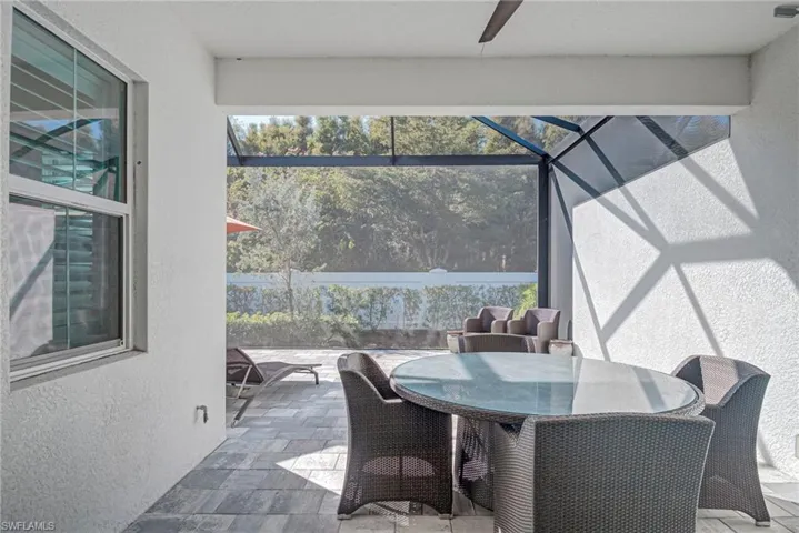 Sunroom with outdoor dining space, a patio, and a ceiling fan