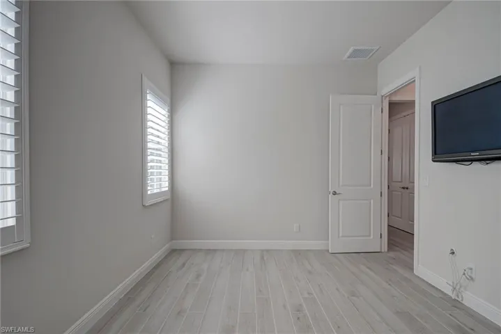 2nd bedroom featuring light wood-style floors and baseboards