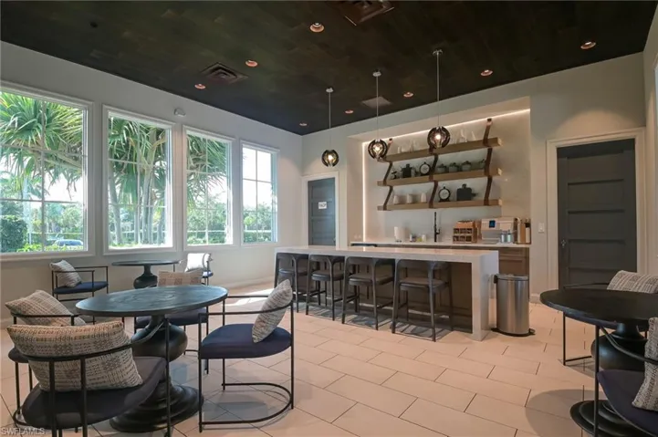 Dining room with wood ceiling, light tile patterned floors, and recessed lighting