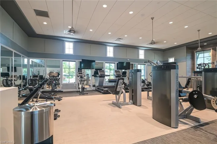 Workout area featuring recessed lighting and a high ceiling