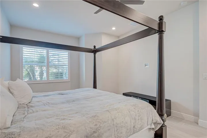 Bedroom featuring light wood-type flooring, ceiling fan, and recessed lighting