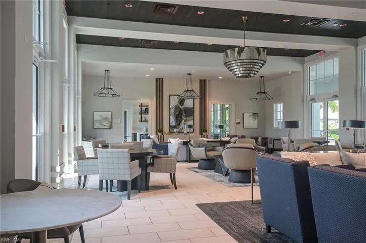 Dining space featuring light tile patterned floors, healthy amount of natural light, a high ceiling, and recessed lighting
