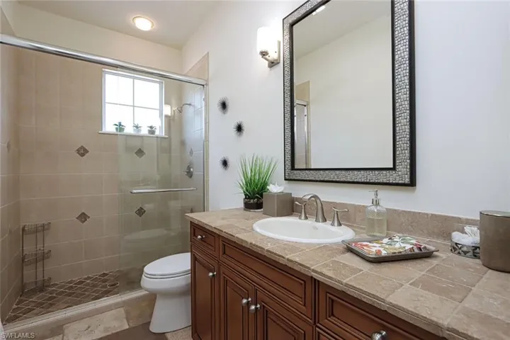 Full bathroom with a stall shower and vanity
