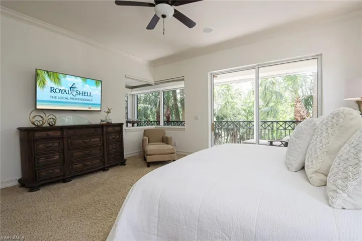 Bedroom featuring access to exterior, ornamental molding, carpet floors, and a ceiling fan