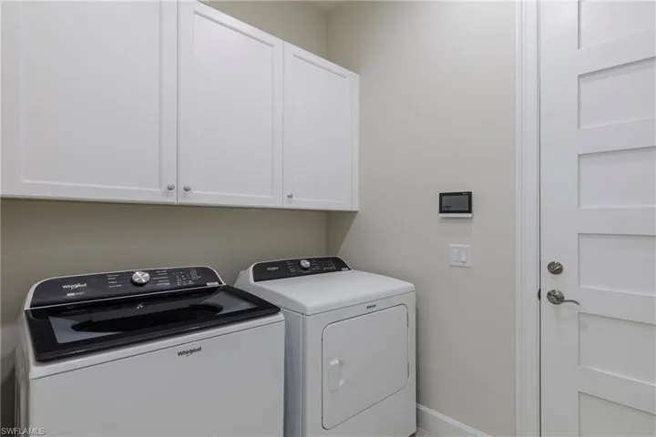 Laundry room with washing machine and clothes dryer and cabinet space
