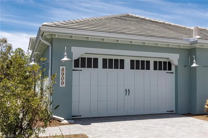 Garage featuring decorative driveway