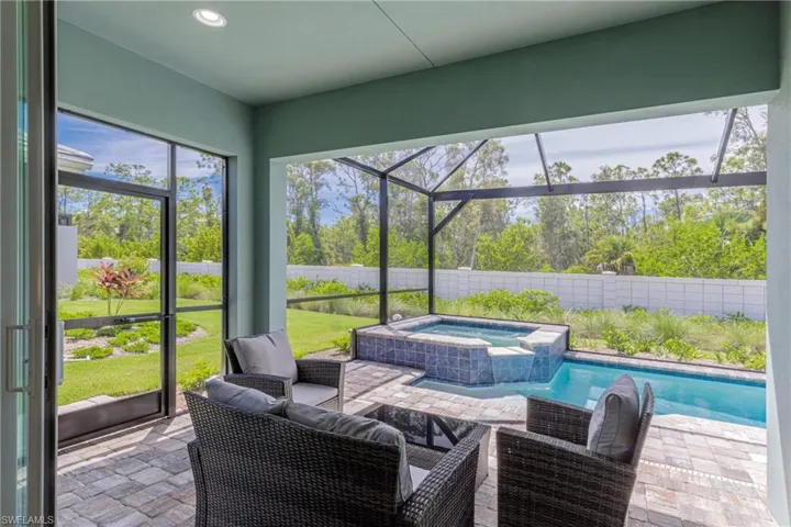 Sunroom with a hot tub