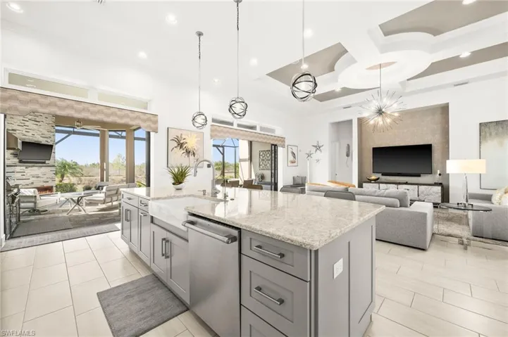 Upgraded kitchen with monogram appliances, built-in refrigerator, R/O system, extra cabinets below island & third row of cabinets.