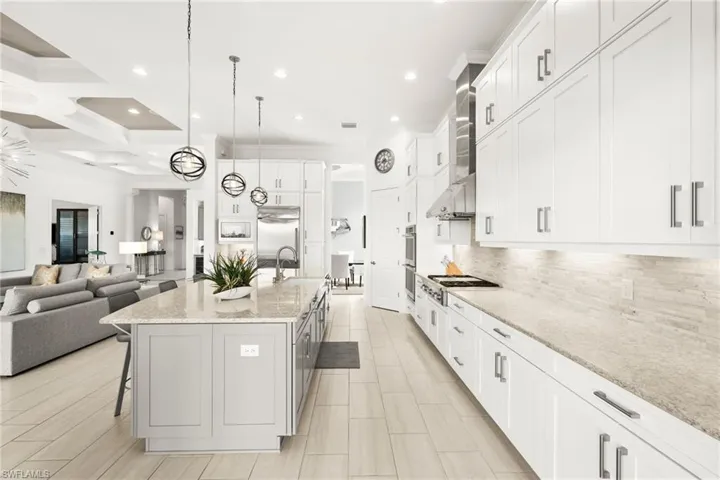 Upgraded kitchen with monogram appliances, built-in refrigerator, R/O system, extra cabinets below island & third row of cabinets.