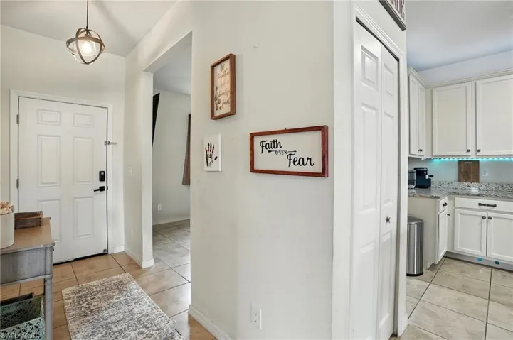 Hall with light tile patterned flooring