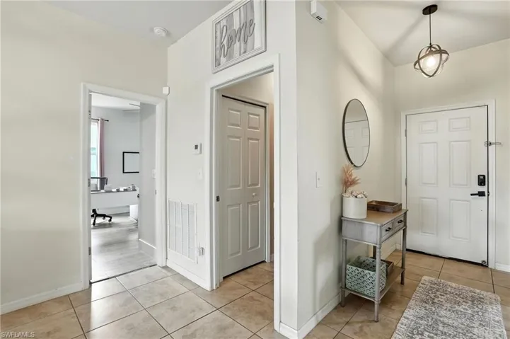 Entryway with light tile patterned floors