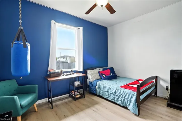 Bedroom featuring wood finished floors and ceiling fan