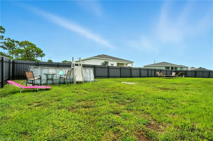Fenced backyard with outdoor dining space