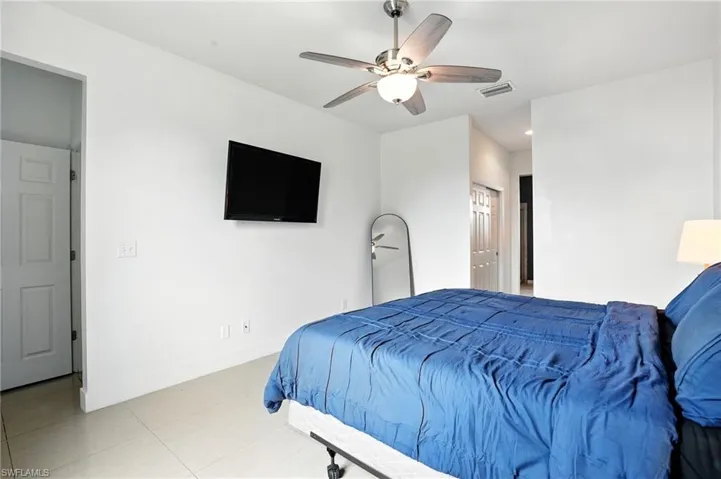 Tiled bedroom featuring ceiling fan and recessed lighting
