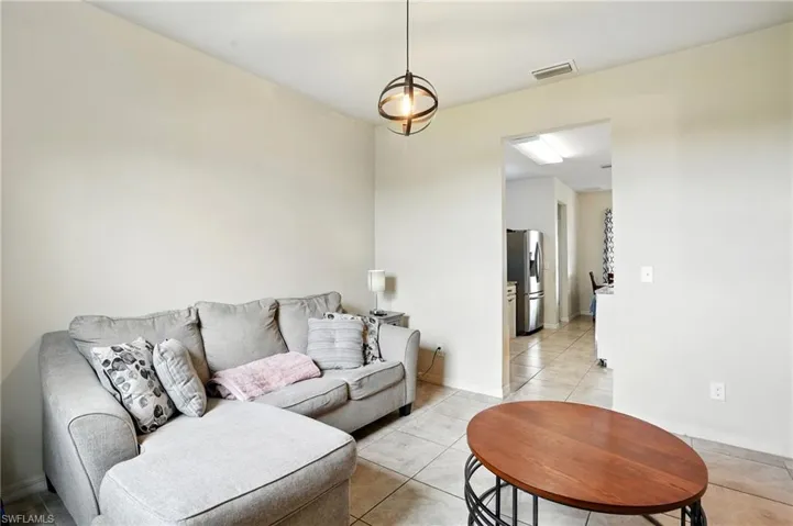 Living room with light tile patterned floors and baseboards
