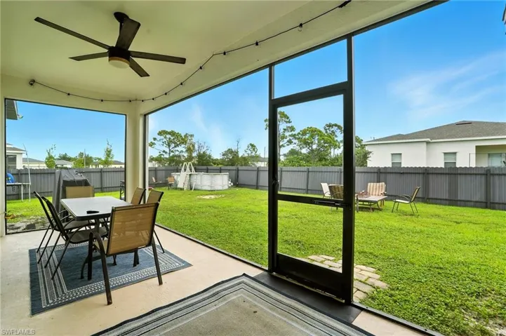 Sunroom with a ceiling fan, outdoor dining space, and a patio