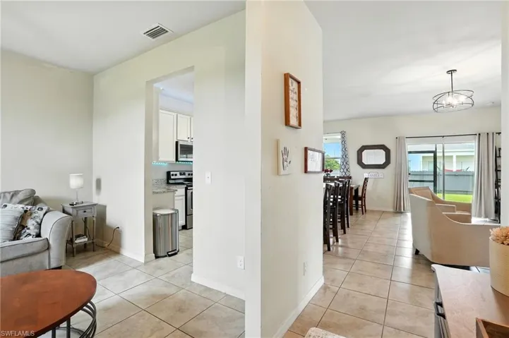 Corridor with light tile patterned floors and baseboards