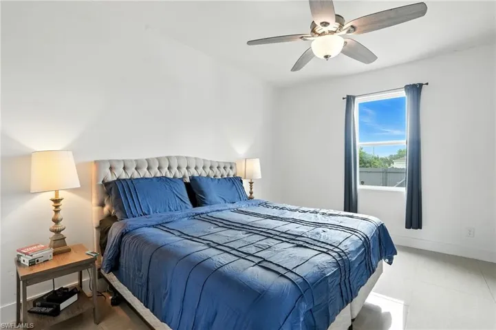Bedroom featuring a ceiling fan and baseboards