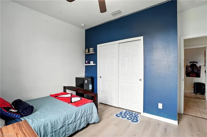 Bedroom featuring wood finished floors, ceiling fan, and a closet