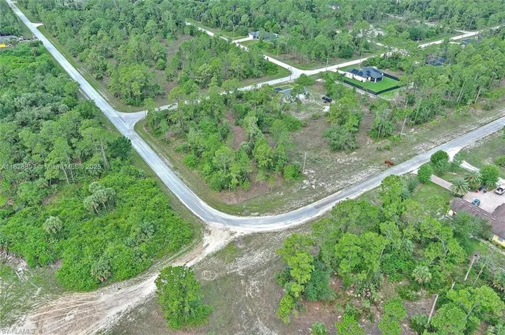 View of property location with a heavily wooded area