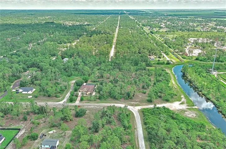 Aerial view of property and surrounding area with a large body of water
