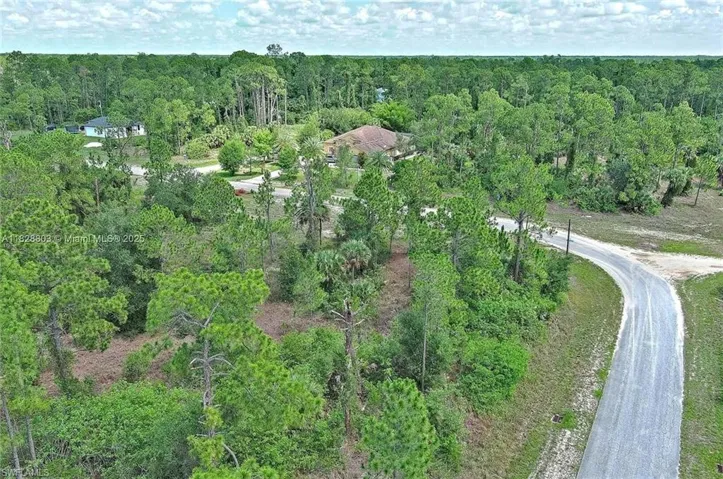 View of property location featuring a heavily wooded area